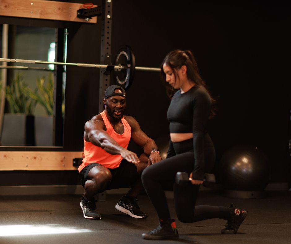 Personal trainer coaching a client during a private training session in Denver.