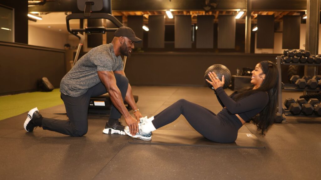 A Denver personal trainer coaching a client at a premier training studio during a tailored workout session.