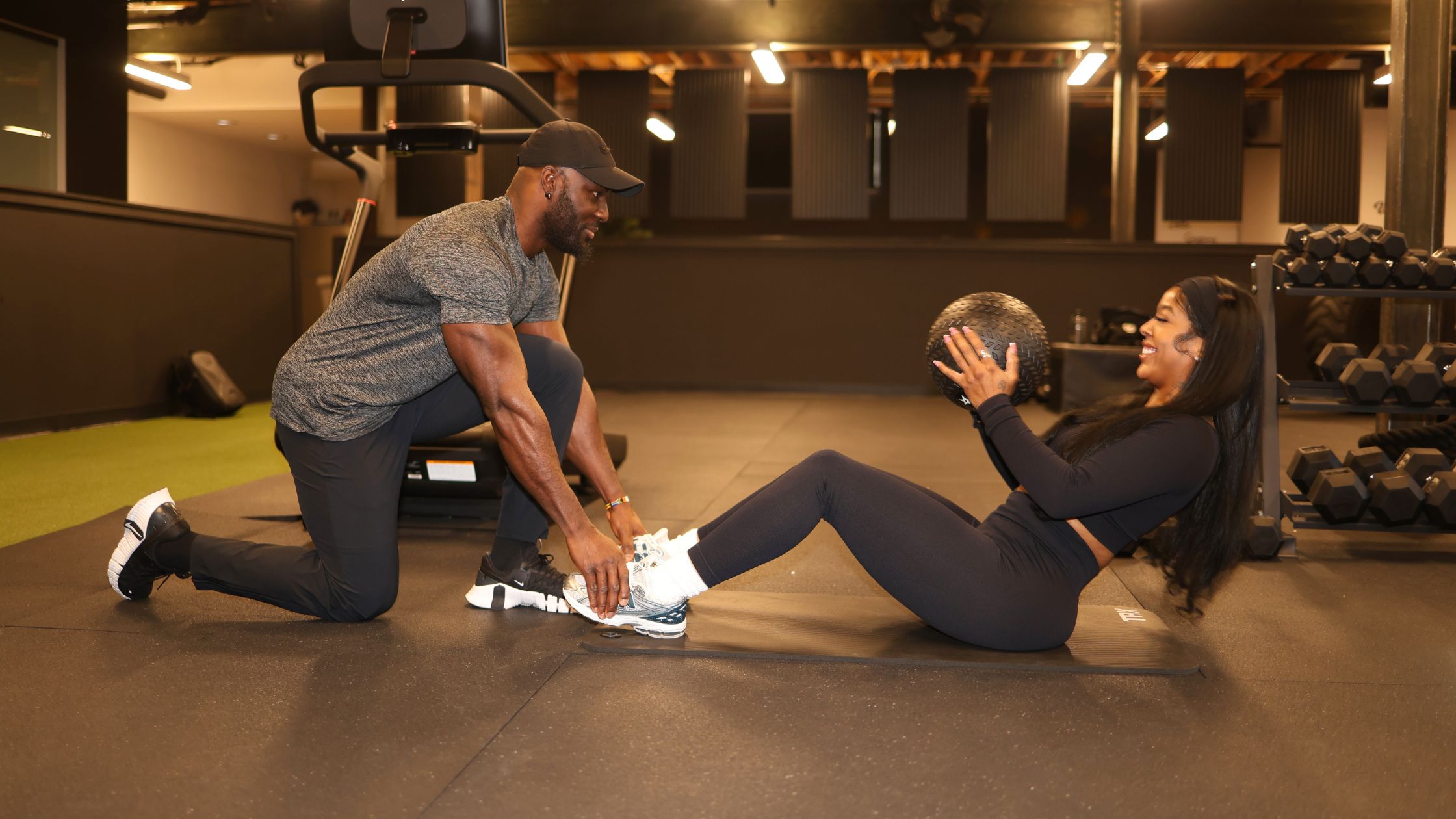 A Denver personal trainer coaching a client at a premier training studio during a tailored workout session.