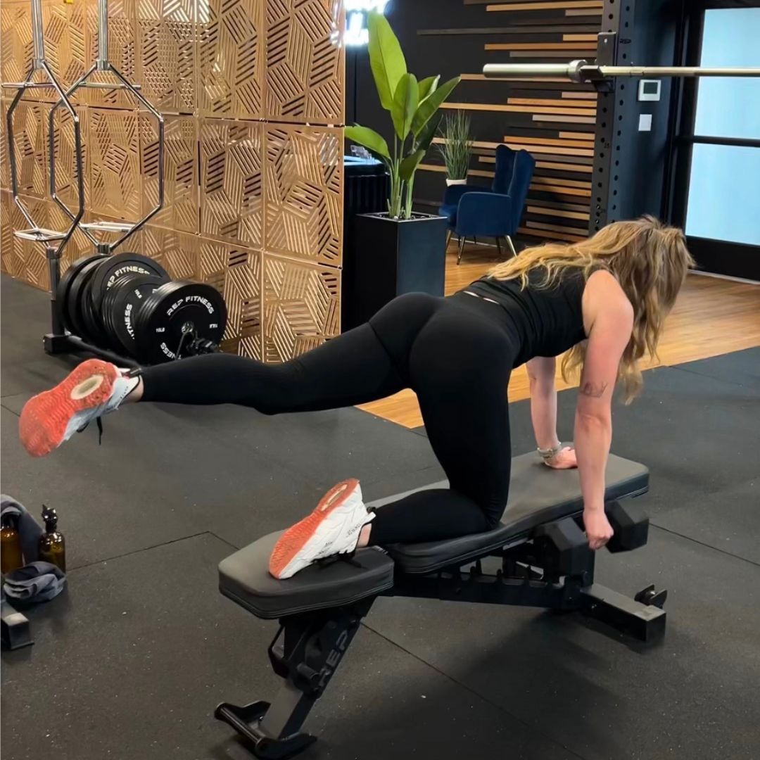Body sculpting workout with a personal trainer in Denver gym.