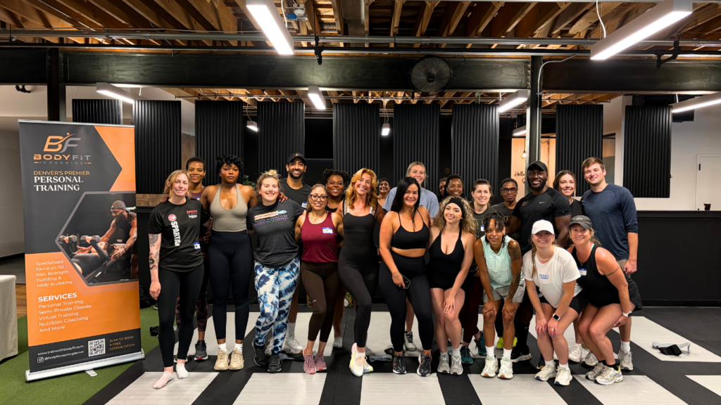 Group picture of attendees after fitness and health activities at the Vital360 wellness event in Denver.