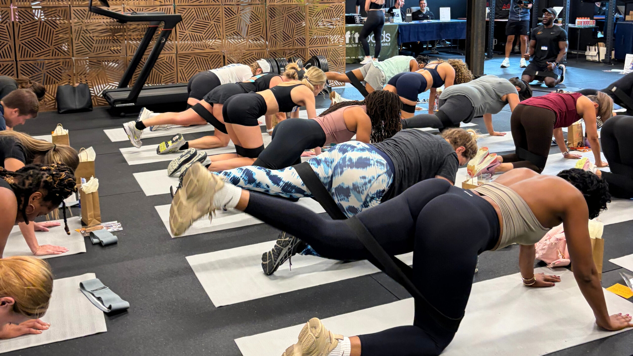 Attendees participating in a full-body sculpt workout session at a Denver wellness event.