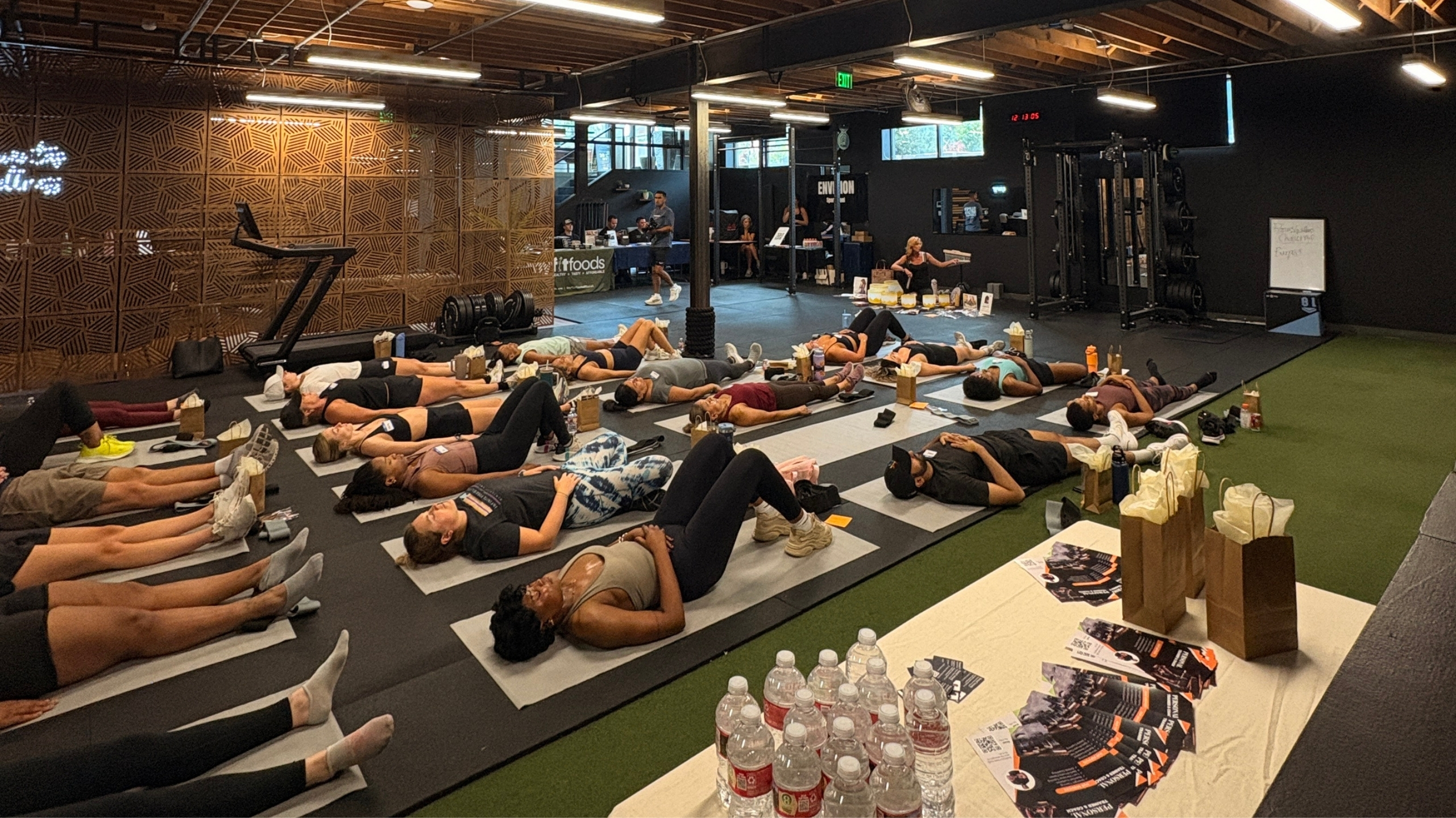 People lying on yoga mats during a sound bath meditation session at a Denver wellness event.